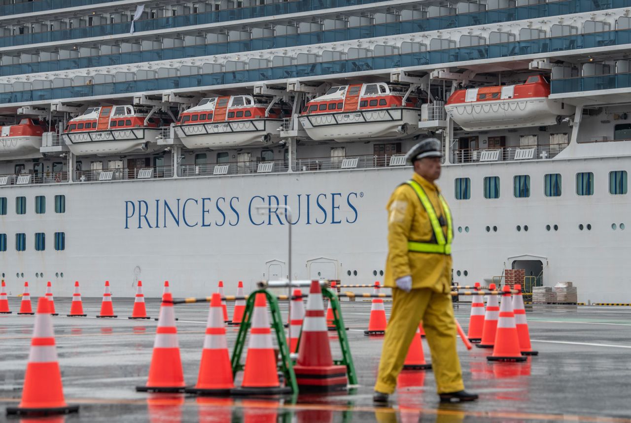 A security guard mans an entrance to Daikoku Pier, where the Diamond Princess cruise ship is being resupplied and newly diagnosed coronavirus cases taken for treatment on February 13 in Yokohama, Japan.