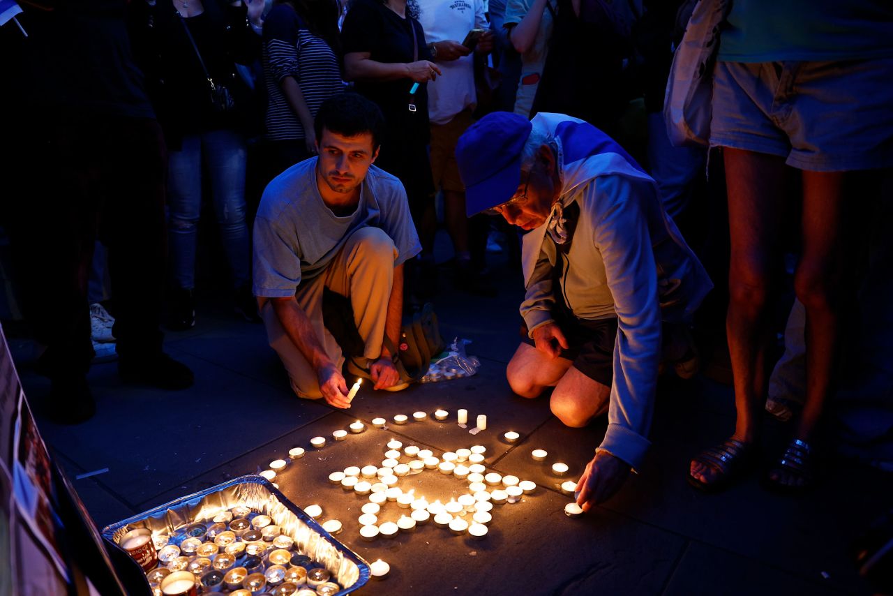 Members of the Jewish community light candles during a vigil for Israel at Downing Street in London on October 9.