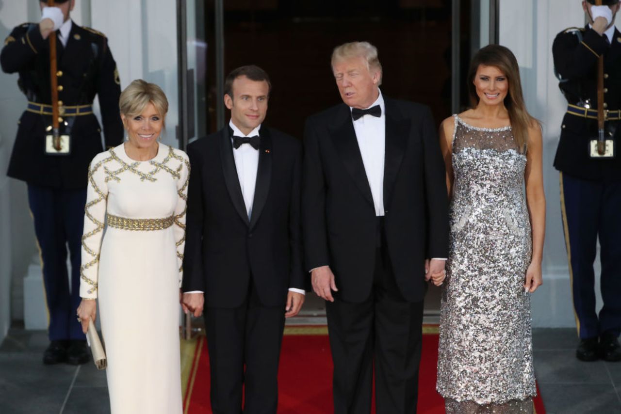 U.S President Donald Trump and U.S. first lady Melania Trump stand with French President Emmanuel Macron and French first lady Brigitte Macron after their arrival at the North Portico before a State Dinner at the White House, April 24, 2018 in Washington, DC.