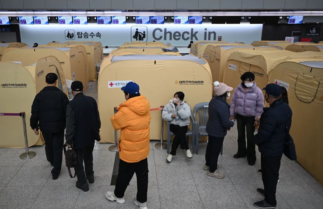 Los familiares de las víctimas del mortal accidente aéreo de Jeju se reúnen en un refugio improvisado en el Aeropuerto Internacional de Muan el 30 de diciembre.