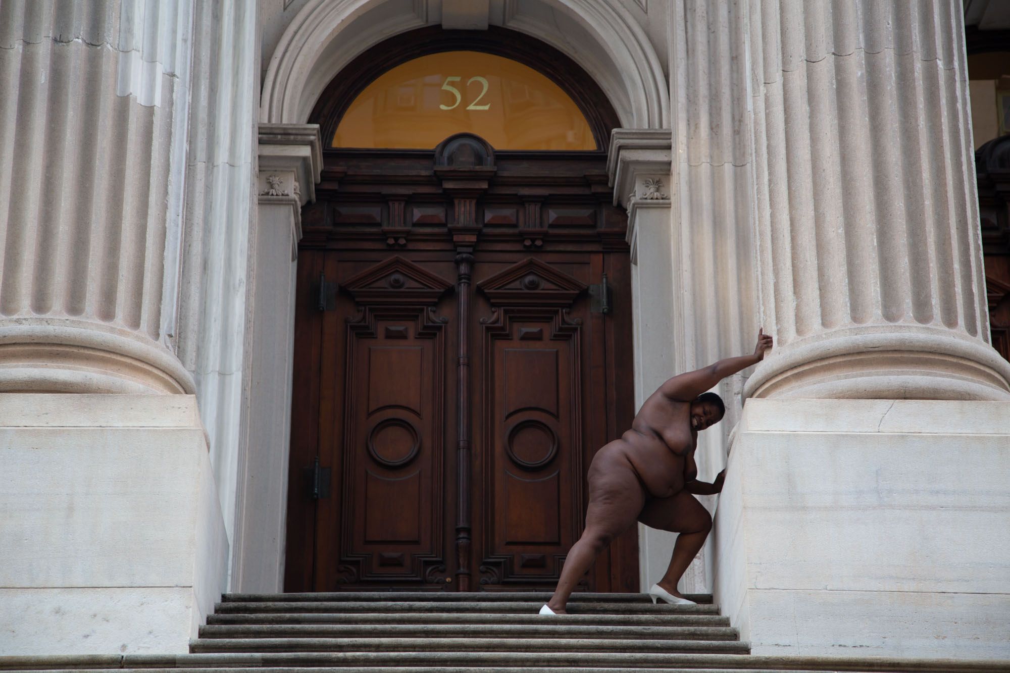 In the 2013 photo "They Tagged The Land With Trophies and Institutions From Their Rapes And Conquests," Nona Faustine poses nude outside the Tweed Courthouse in downtown New York, placing herself — and the viewer — in direct conflict with the building itself.