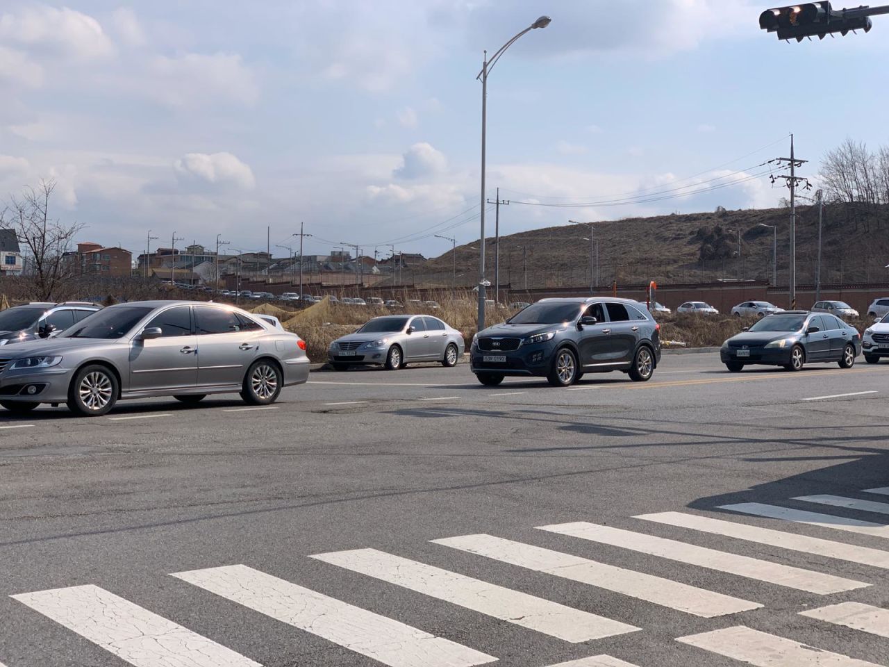 A long line of cars waiting hours to enter the military base Camp Humphreys in South Korea. 