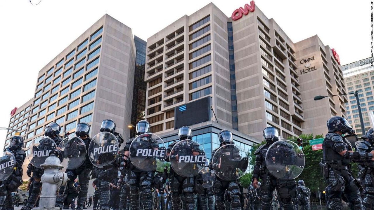 Police stand guard around the CNN Center and Centennial Olympic park as protests continue over the death of George Floyd, on Saturday, May 30, in Atlanta.