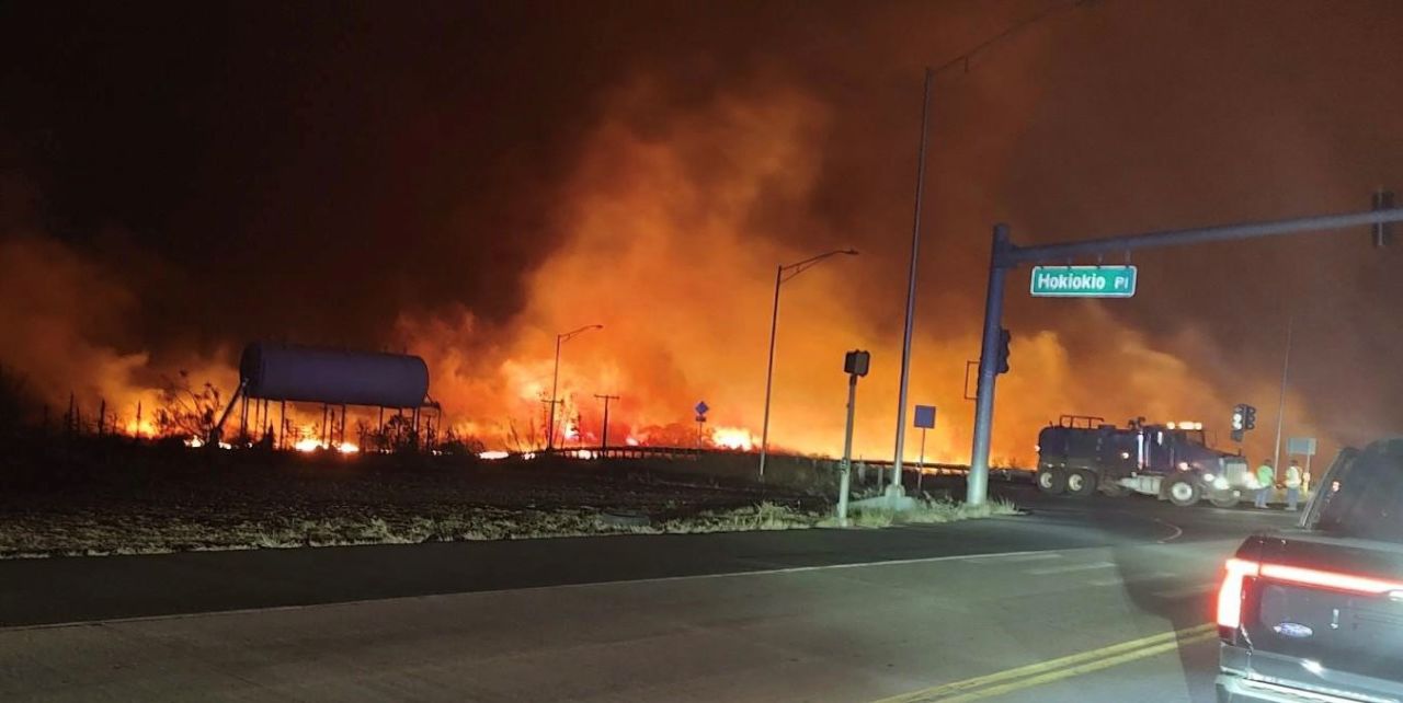 Flames are seen at the intersection of Hokiokio Place and Lahaina Bypass in Maui, Hawaii, on Tuesday night.