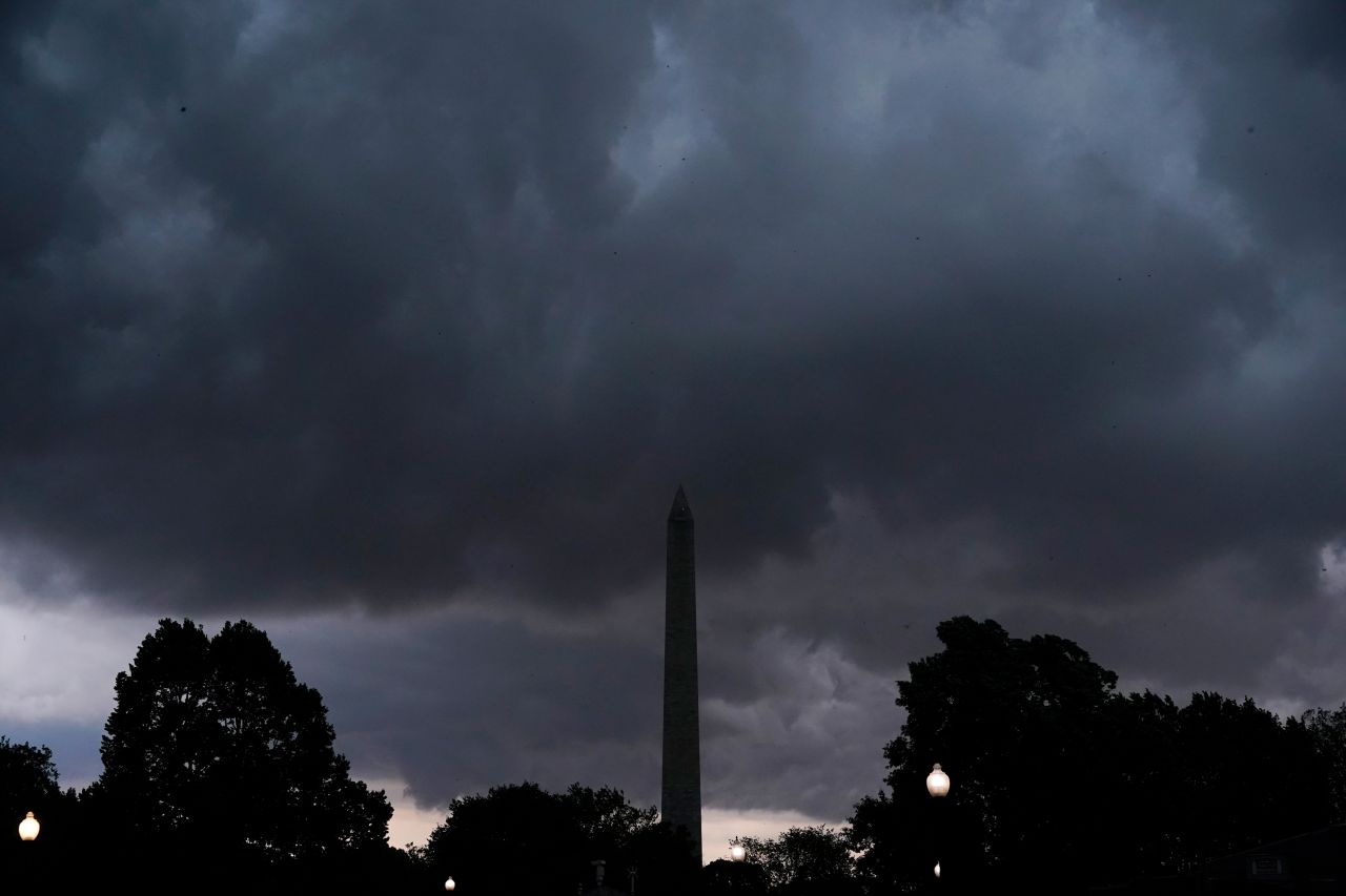 Storm clouds darken the sky over the Washington Monument in Washington, DC, on Monday.