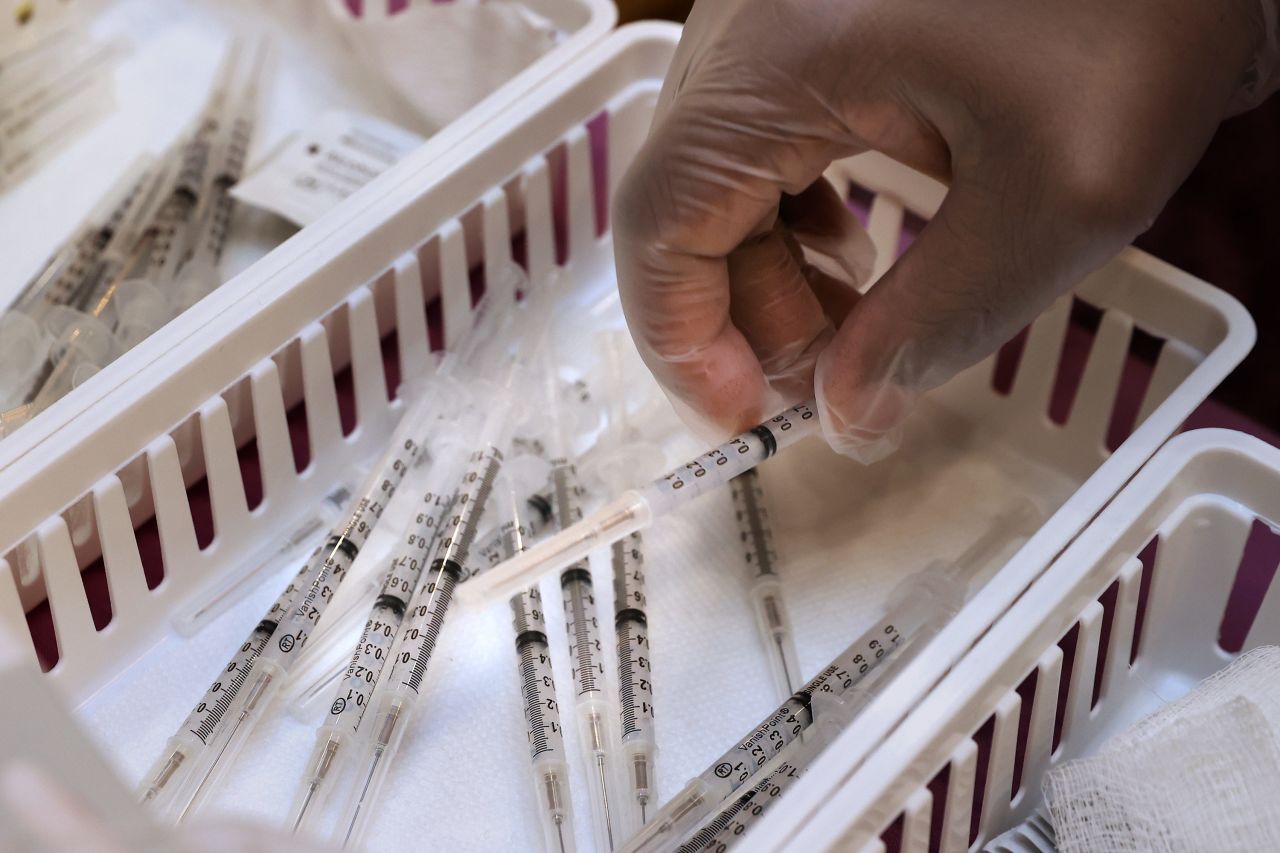 Pharmacist Fedelis Onyimba prepares to administer a Moderna COVID-19 vaccine dose at First Baptist Church of Highland Park on March 18 in Landover, Maryland. 