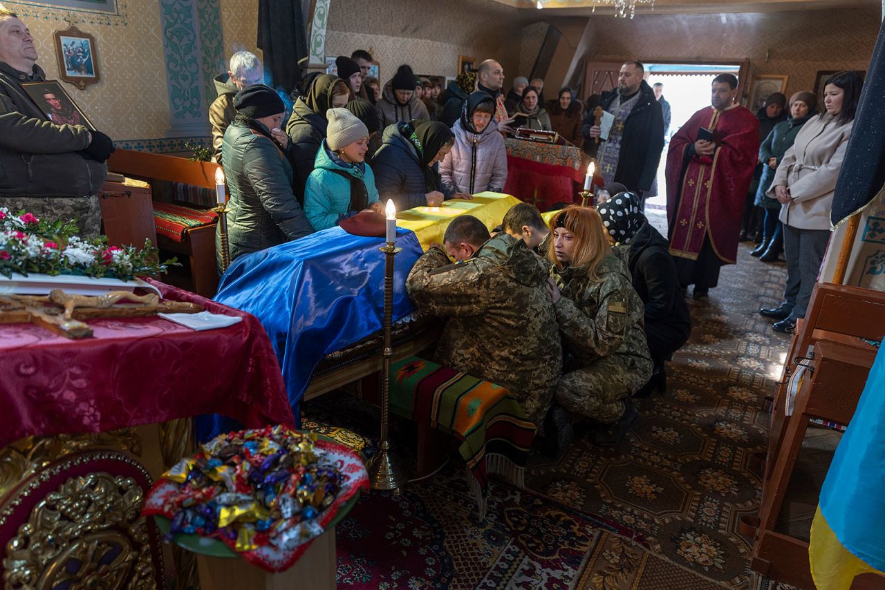 Sergey Zhelisko, center, family and friends mourn at the casket of his son, Ukrainian soldier Dmitry Zhelisko, during his funeral at the Church of St. Luke on April 03 in Rusyn, Ukraine. Zhelisko died fighting the Russian army near the town of Kharkiv. 