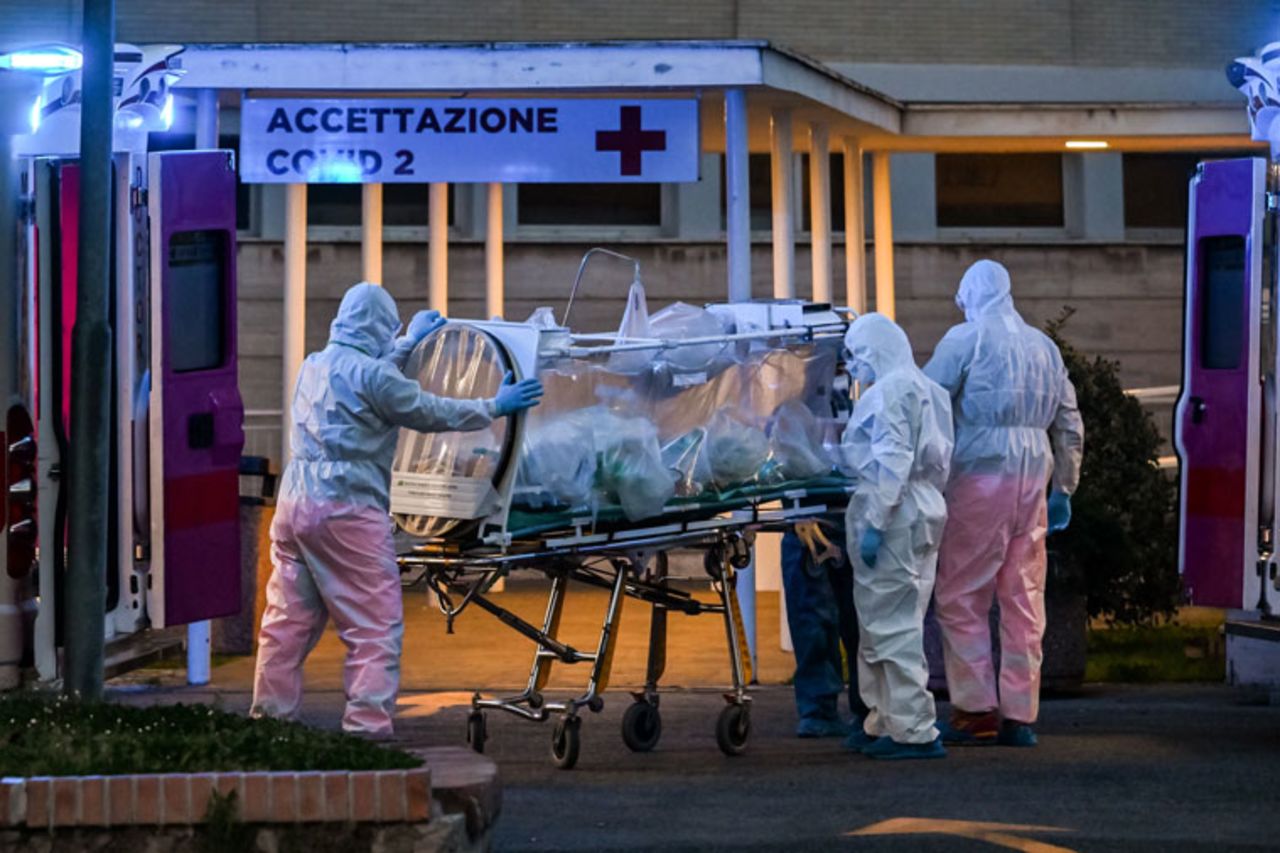 Medical workers in overalls stretch a patient under intensive care into the newly built Columbus Covid 2 temporary hospital to fight the new coronavirus infection, on March 16 at the Gemelli hospital in Rome. 