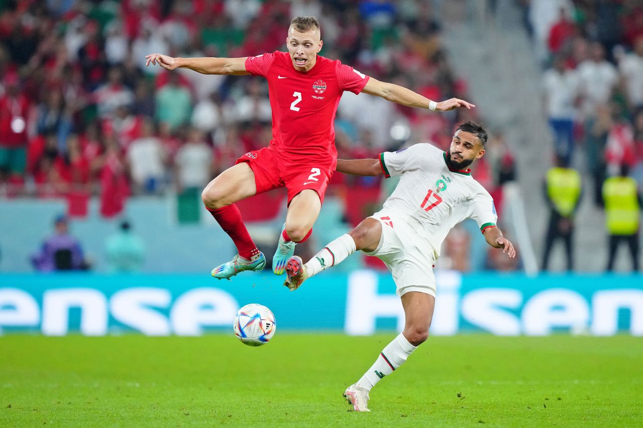 Canada's Alistair Johnston, left, battles for the ball against Morocco's Sofiane Boufal.