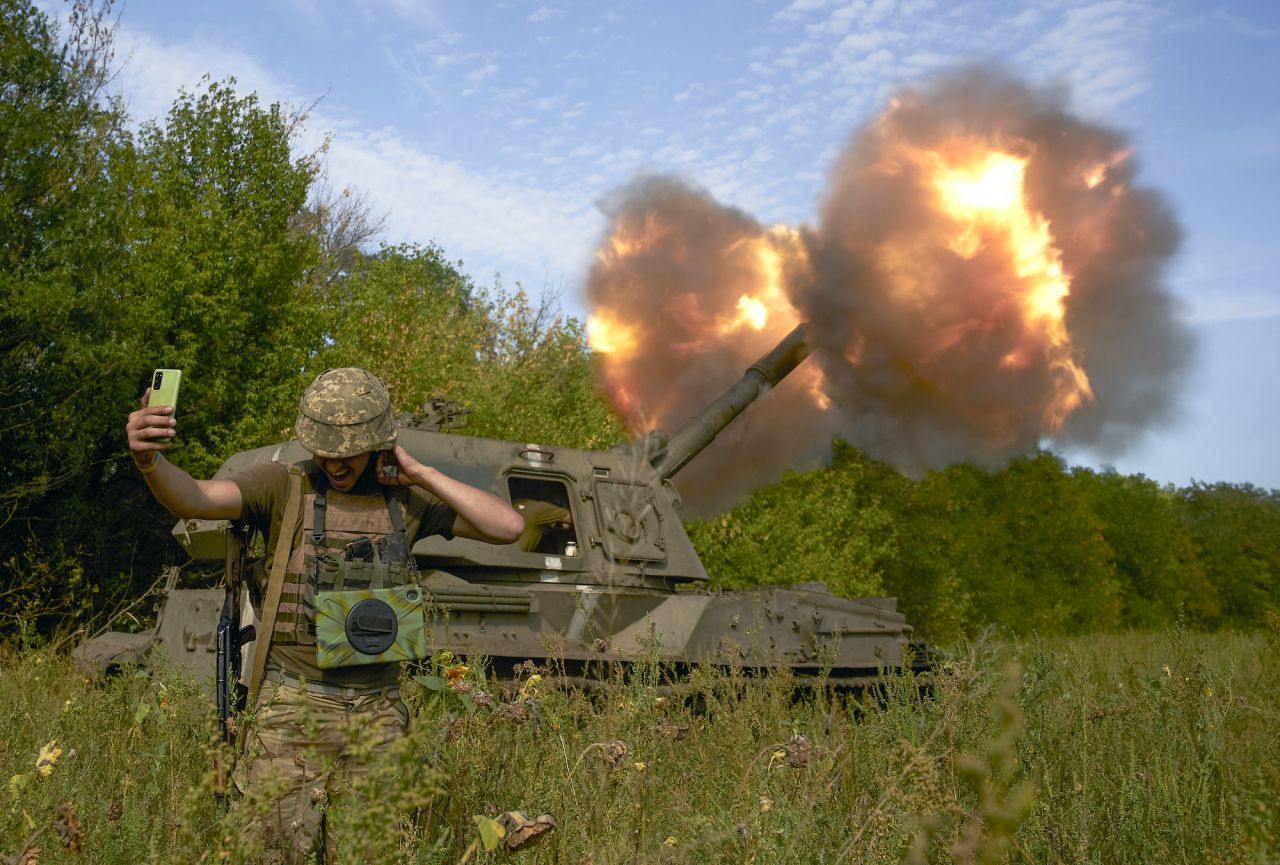 A Ukrainian soldier takes a selfie as an artillery system fires on the front line in the Donetsk region on September 3.
