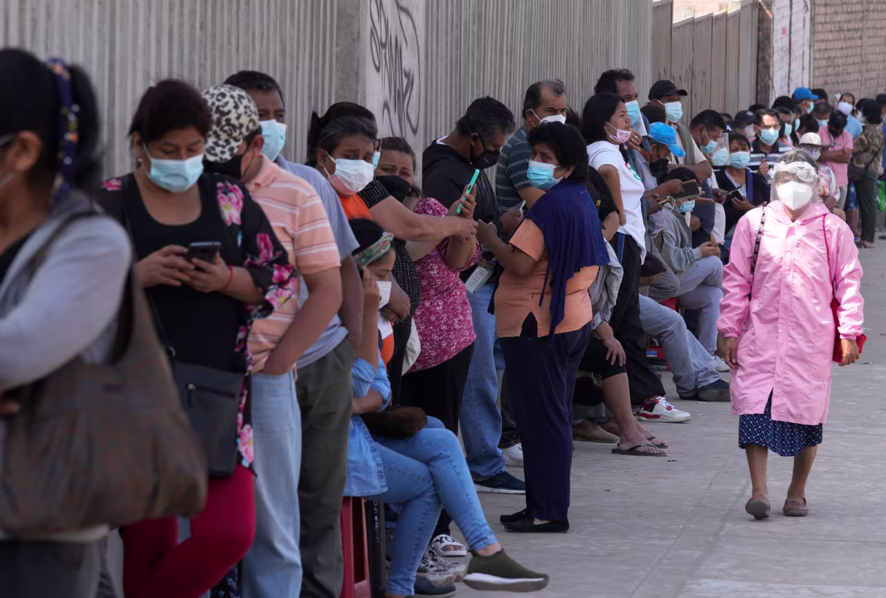 People stand in line to wait for PCR tests in Lima, Peru, on Wednesday, January 5.