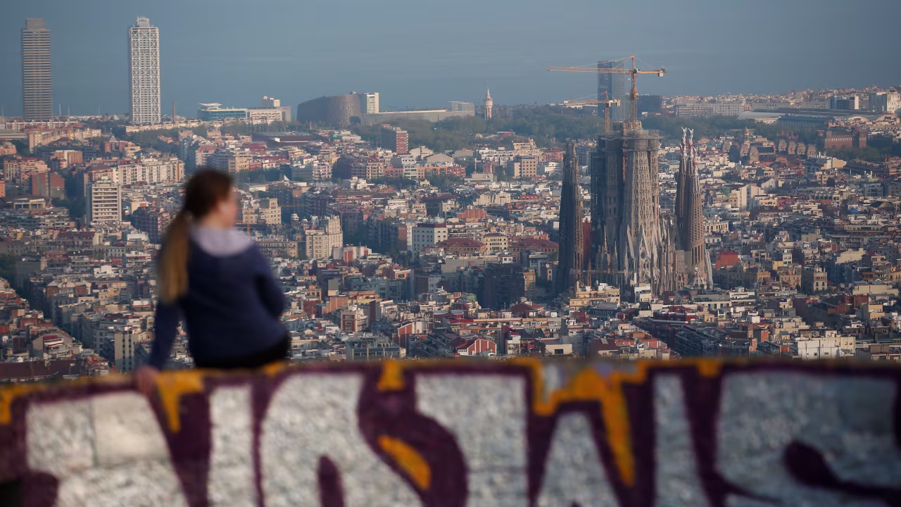 A woman looks over Barcelona on April 10, during a national lockdown to prevent the spread of the Covid-19 disease.