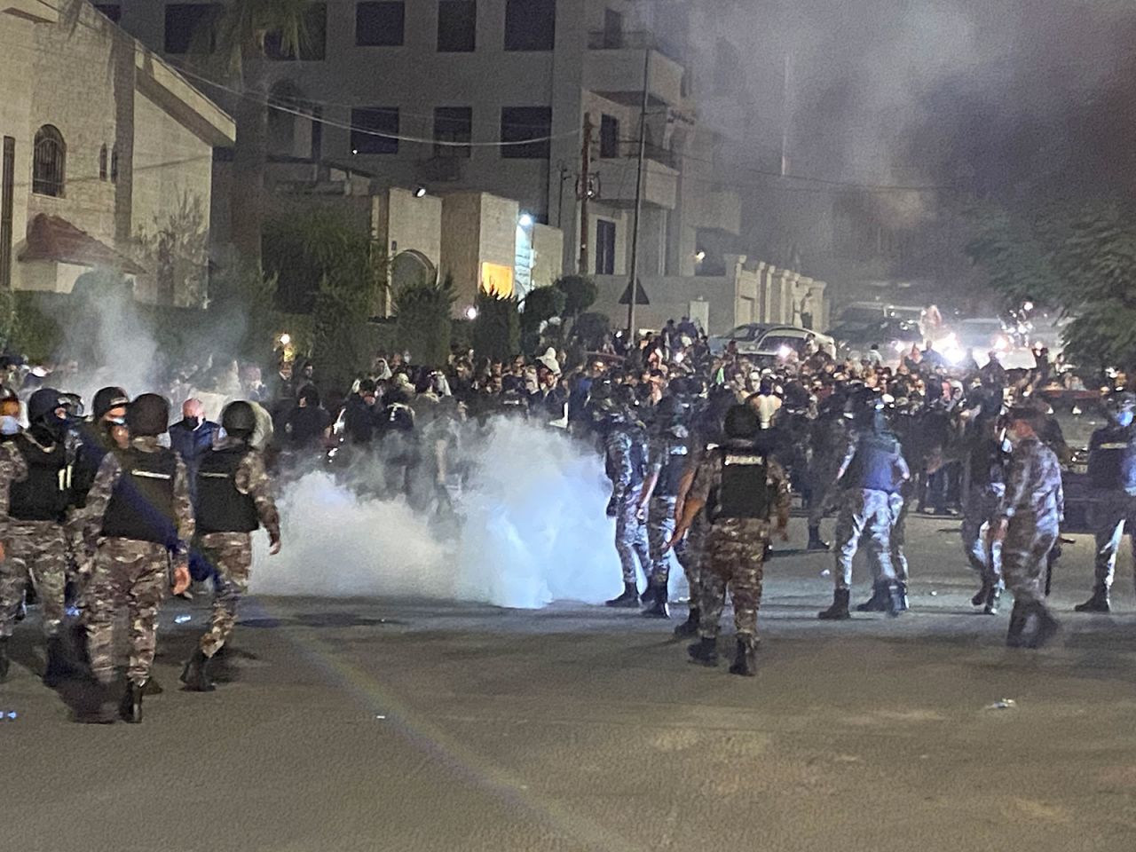 Jordanian security forces fire tear gas against demonstrators attempting to storm the Israeli embassy in the capital Amman, on Tuesday, October 17, 2023. 