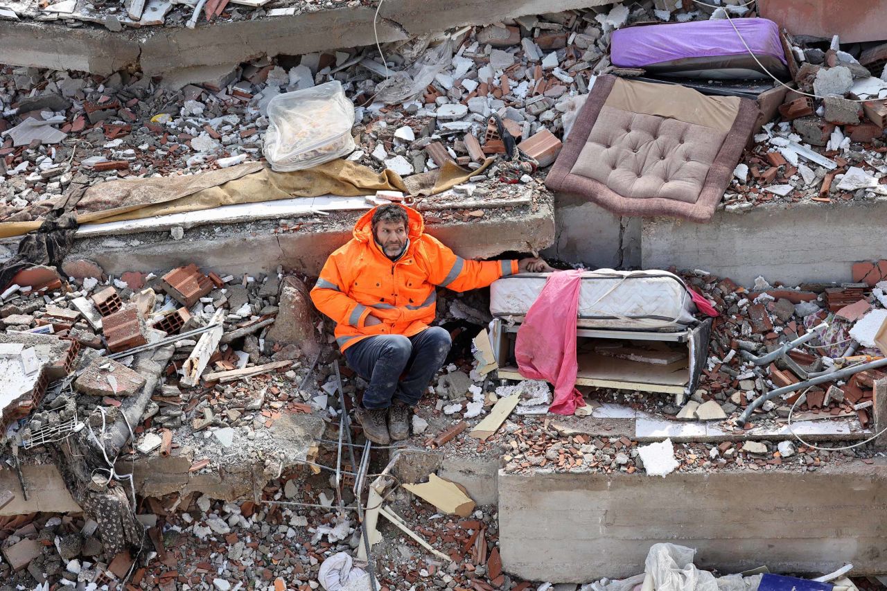 Mesut Hancer holds the hand of his 15-year-old daughter Irmak, who was killed in the earthquake.