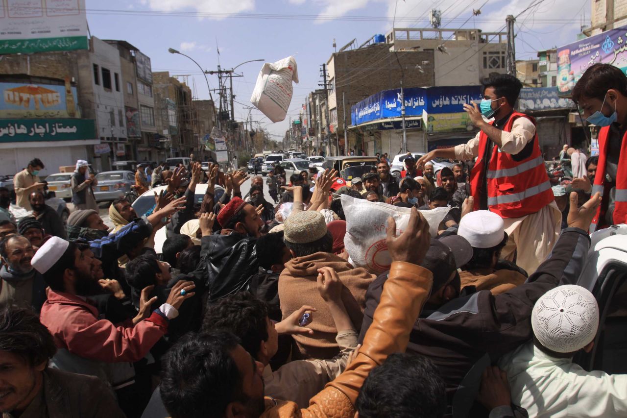 Daily wage workers, unemployed due to the coronavirus outbreak, jostle for free food supplies being distributed in Quetta, Pakistan, on Tuesday.