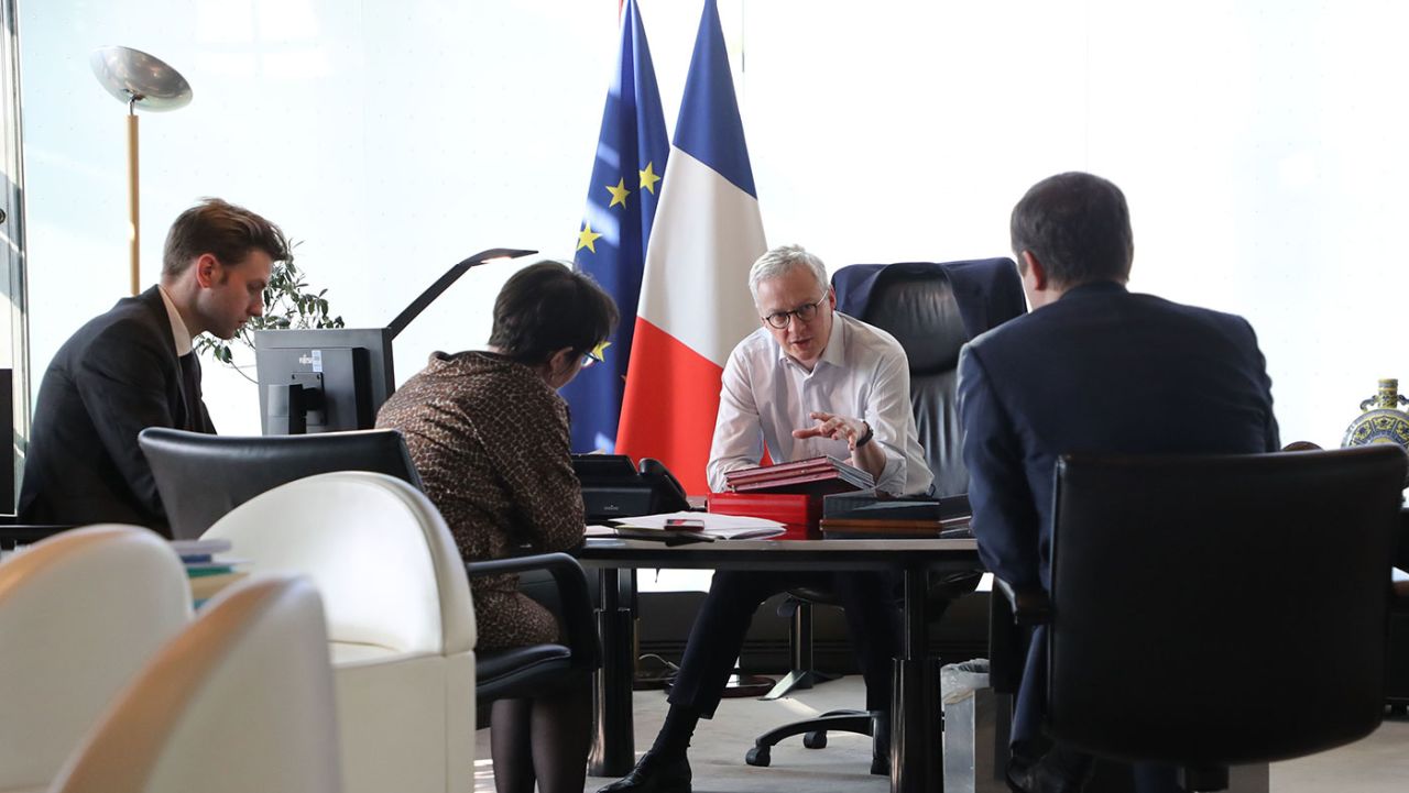 French Finance Minister Bruno Le Maire speaks with other officials in the minister's office in Paris on April 9. 