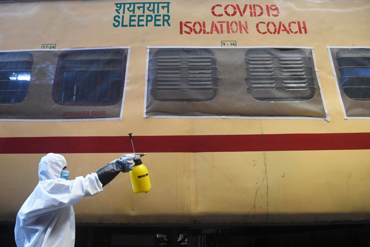 A worker in protective gear sprays disinfectant on a train carriage converted into an isolation ward for Covid-19 patients during a government-imposed nationwide lockdown in Howrah near Kolkata on April 5.