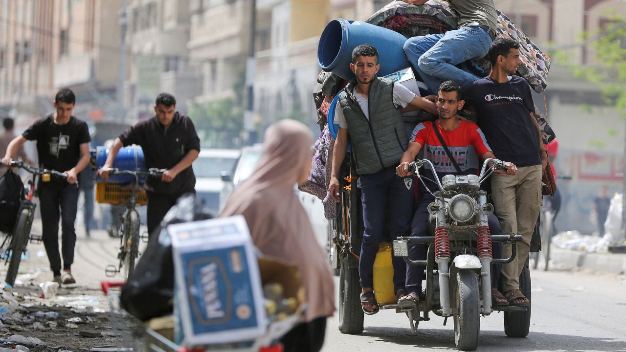 People ride on a vehicle loaded with belongings as Palestinians evacuate the eastern part of Rafah, Gaza, on May 11.