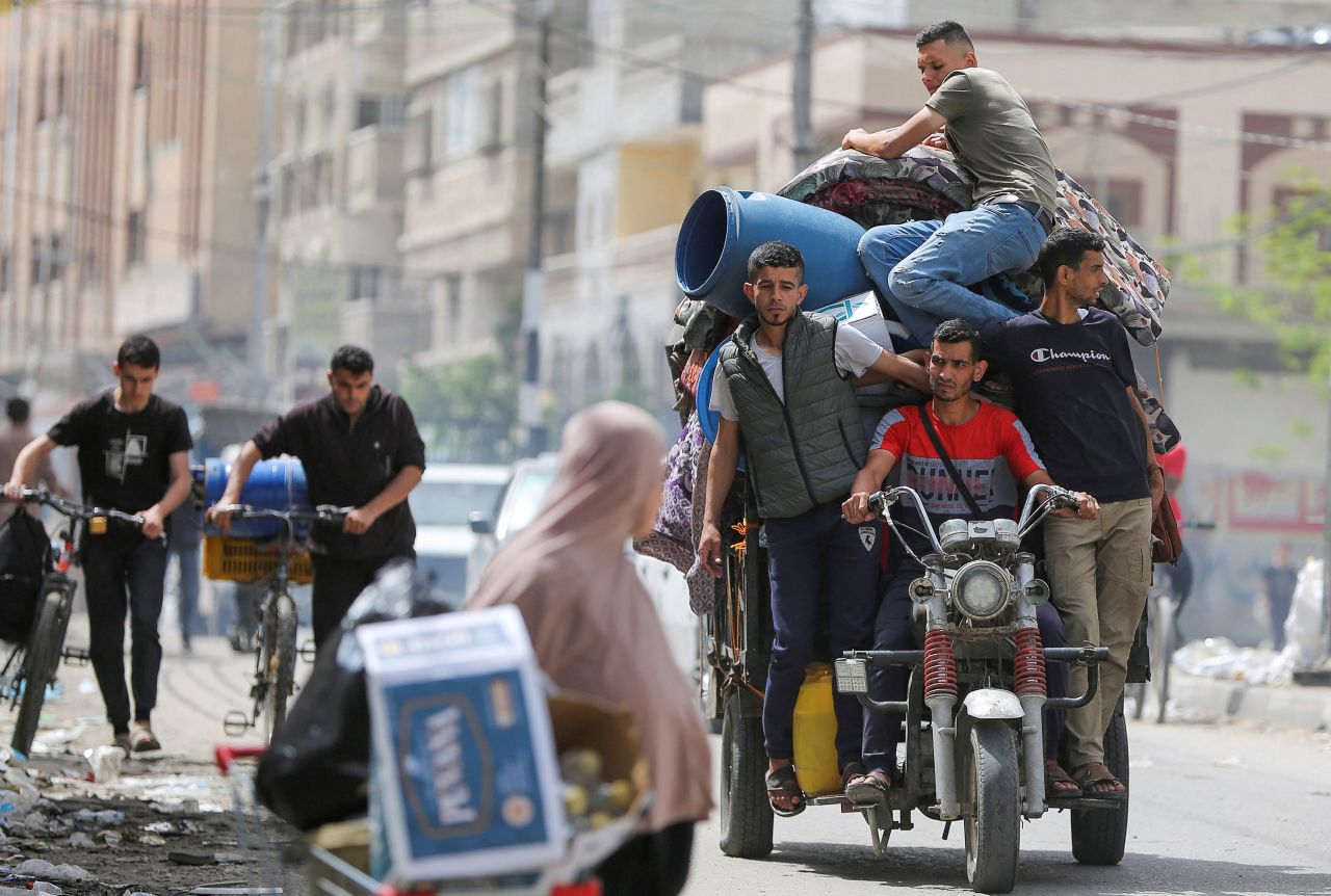 People ride on a vehicle loaded with belongings as Palestinians evacuate the eastern part of Rafah, Gaza, on May 11.