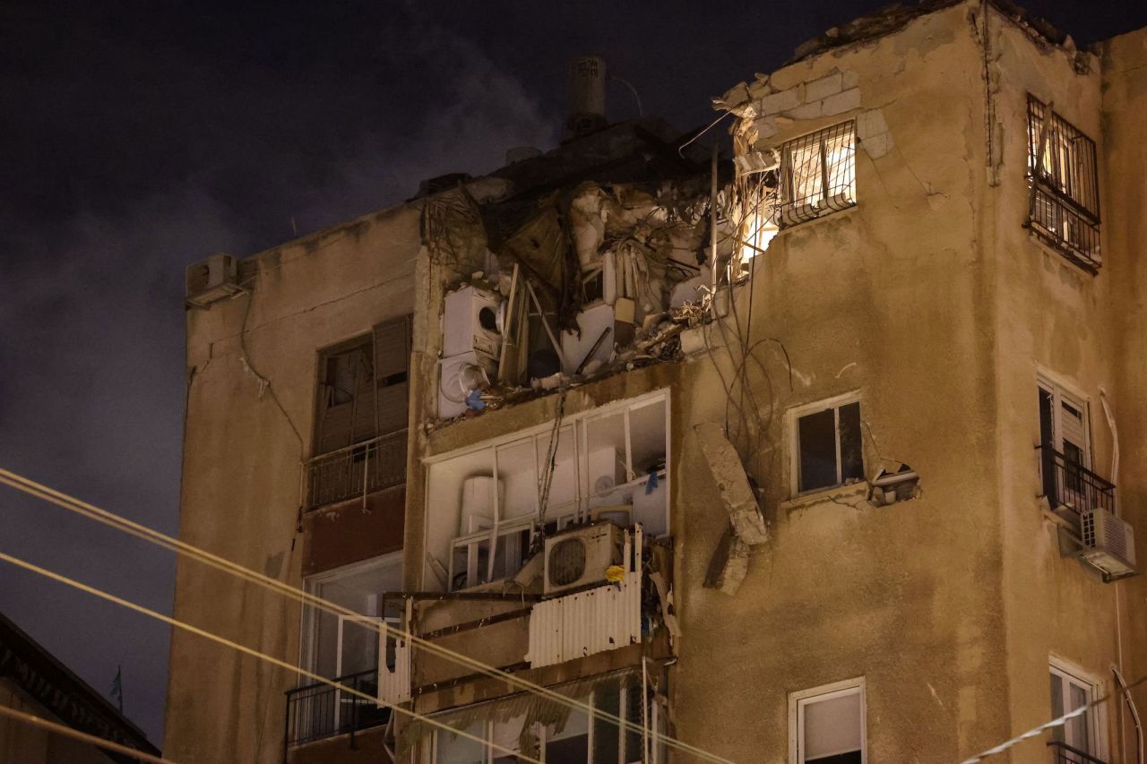 A building in Tel Aviv is damaged by a rocket fired by Palestinian militants from Gaza on October 7, 2023.