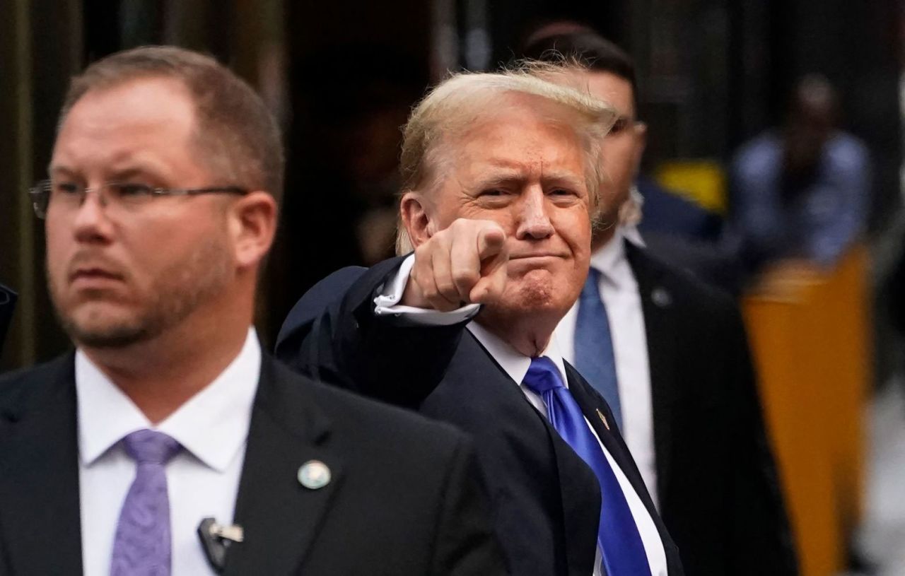 Trump points as he arrives back at Trump Tower in New York after his conviction on May 30. 