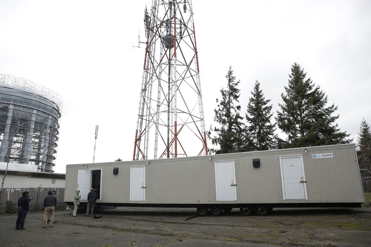 Media tours the first of 18 four-room modular housing units being prepared for patient accommodation during treatment and isolation in King County's response to coronavirus on a site in White Center, south of Seattle, Washington on Tuesday, March 3.