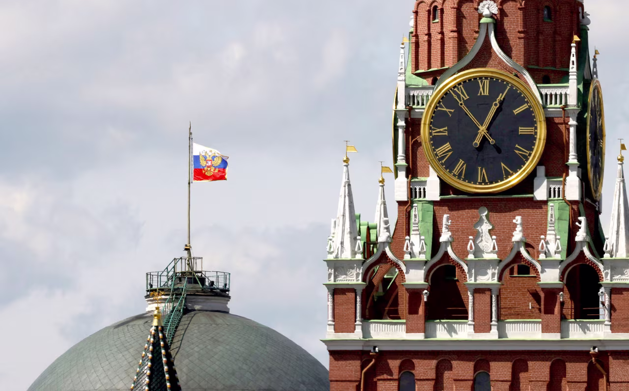 The Russian flag flies on the dome of the Kremlin Senate building behind Spasskaya Tower, while the roof shows what appears to be marks from the recent drone incident, in central Moscow, Russia, on May 4.