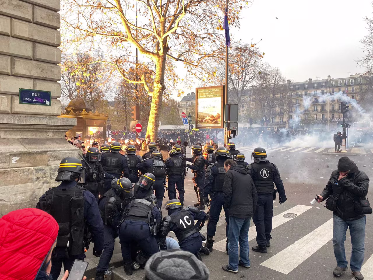 Police pin down a protester after hurling tear gas at demonstrators.