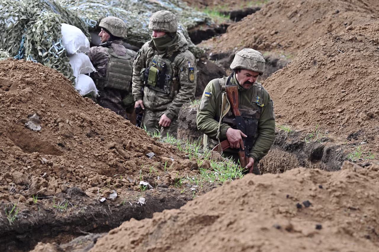 Ukrainian servicemen stand in a trench near Bakhmut, Ukraine, on April 8. 