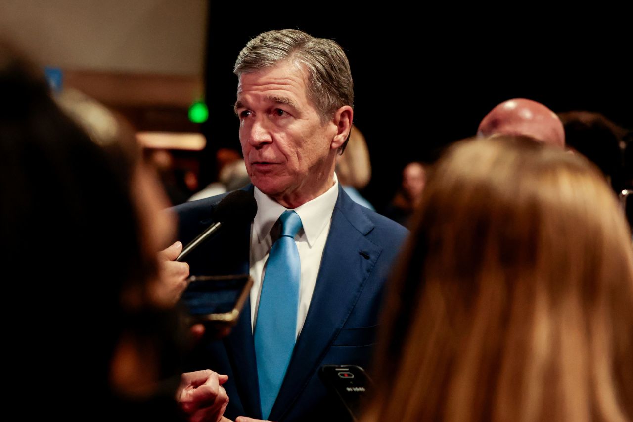 Gov. Roy Cooper speaks to members of the media in the spin room following the presidential debate on Tuesday.