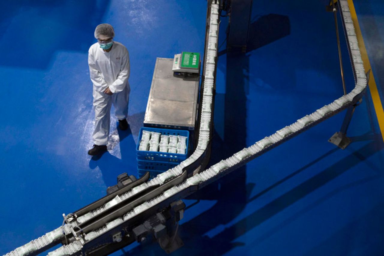 A worker monitors the production line at the Mengniu dairy factory in Beijing on Thursday, February 27.