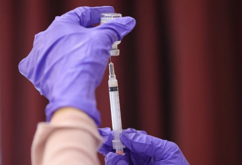 A nurses draws a Moderna vaccine dose from a vial at the Cameron Grove Community Center on March 25 in Bowie, Maryland. 
