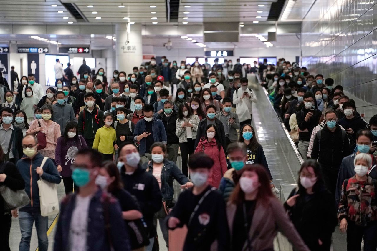 Commuters wear face masks during rush hour inside a subway station in Hong Kong, March 11.