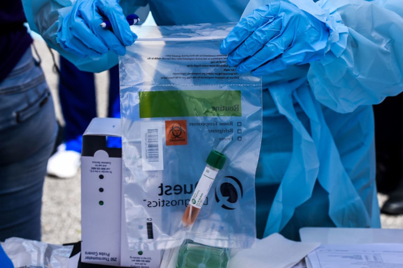 A medical personnel store medical samples of patients at a "drive-thru" coronavirus testing lab set up by local community centre in West Palm Beach 75 miles north of Miami, on March 16.