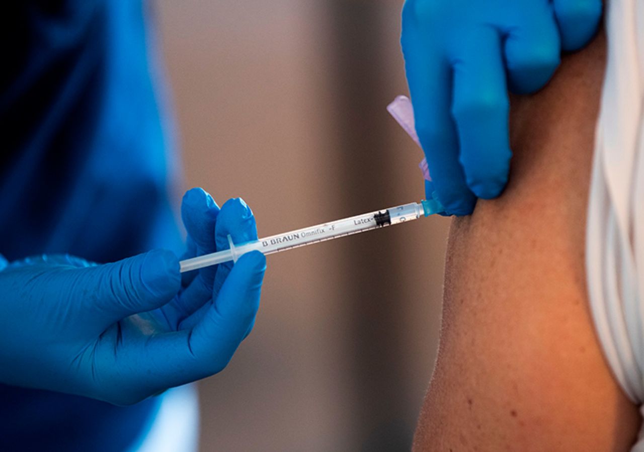 A health worker vaccinates an elderly person with the Biontech-Pfizer Covid-19 vaccine at a temporary vaccination clinic in a church in Sollentuna, north of Stockholm on March 2, 2021. 