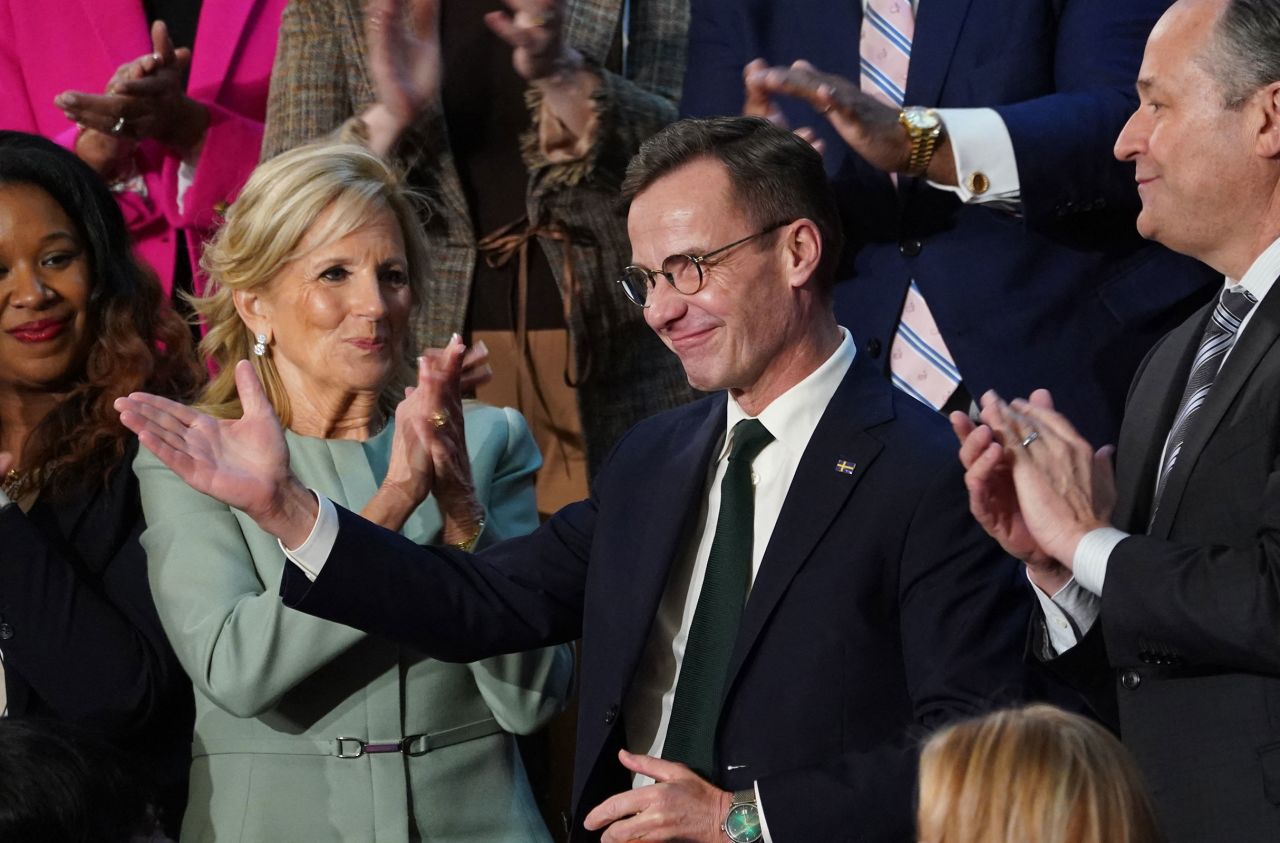 First lady Dr. Jill Biden applauds as Swedish Prime Minister Ulf Kristersson waves.