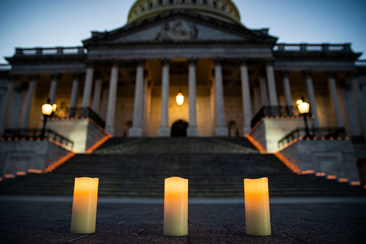 Candles are placed before a candlelight vigil and moment of silence outside the U.S. Capitol, on February 23, 2021 in Washington, DC. Congressional leaders held a candlelight ceremony to mark the more than 500,000 U.S. deaths due to the COVID-19 pandemic. 