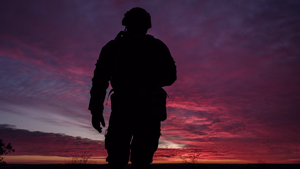 A Ukrainian serviceman poses at a checkpoint at sunset in the Donetsk region on February 9.