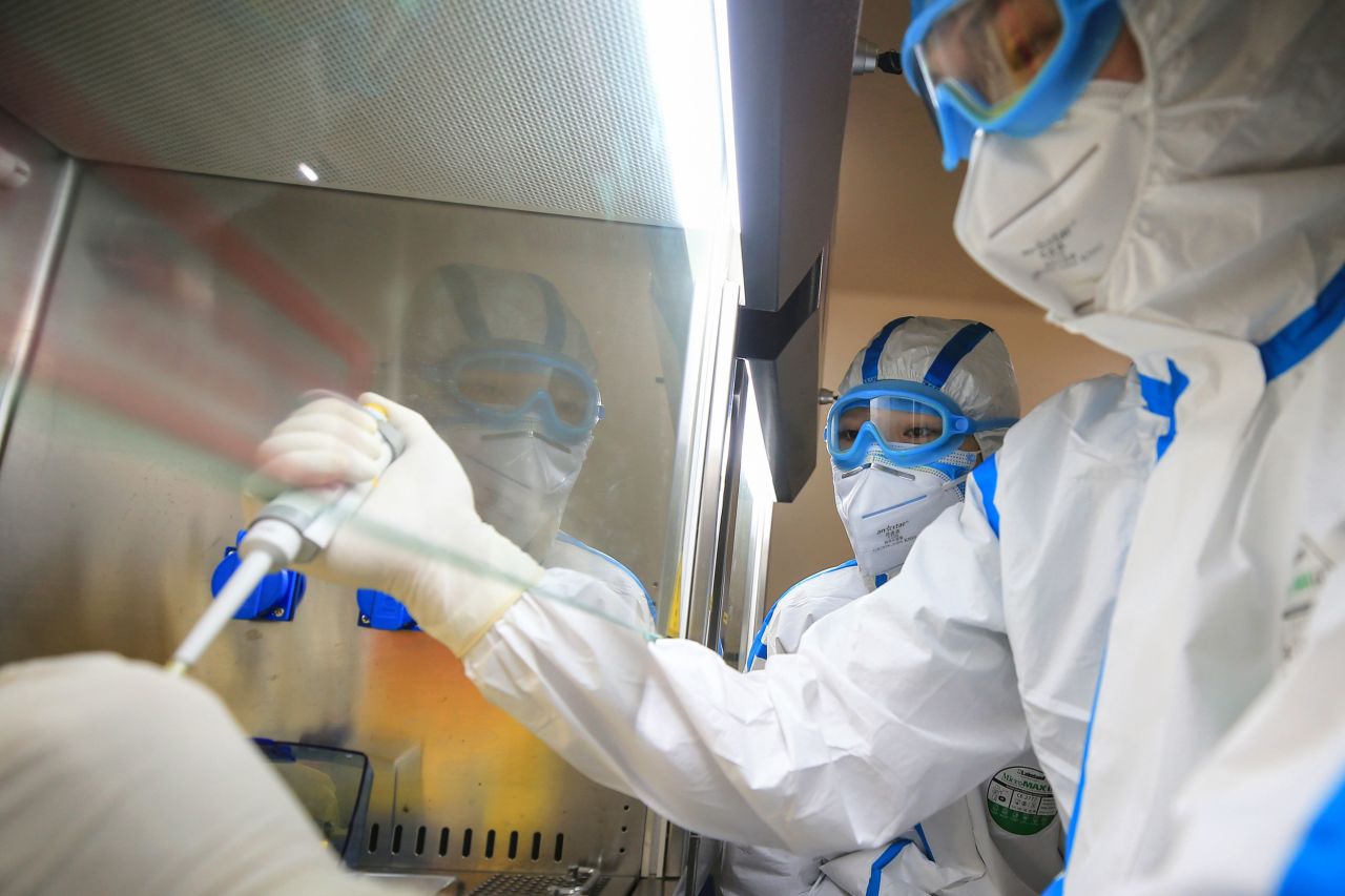 Laboratory technicians testing samples of virus at a laboratory in Hengyang in China's central Henan province.?