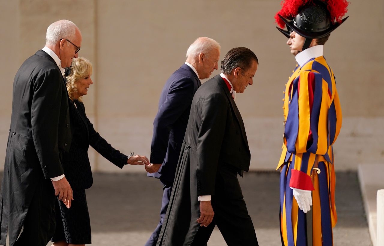 First lady Jill Biden reaches out to touch the hand of President Joe Biden as they arrive for a meeting with Pope Francis at the Vatican on October 29.