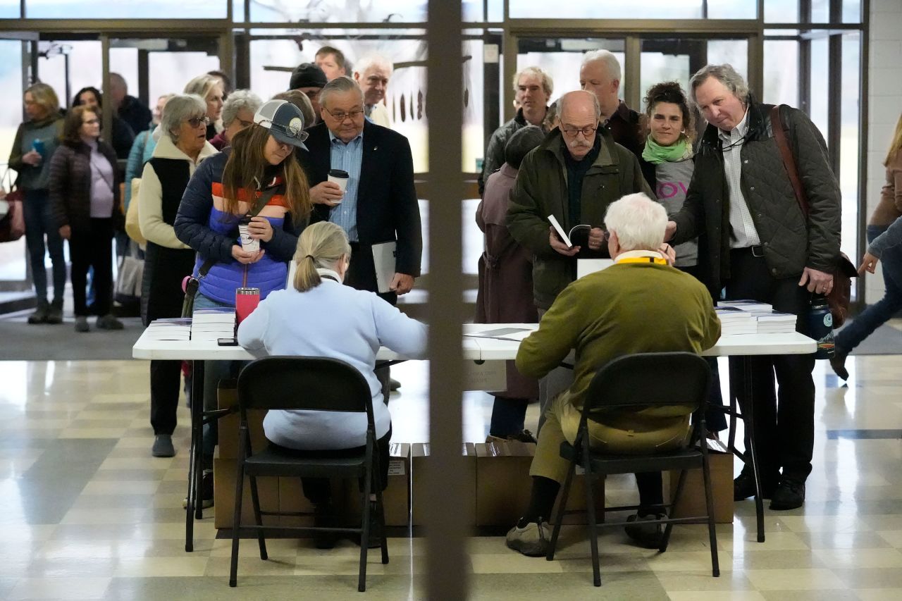 People sign in before attending a town meeting and voting in the primary election in Stowe, Vermont.