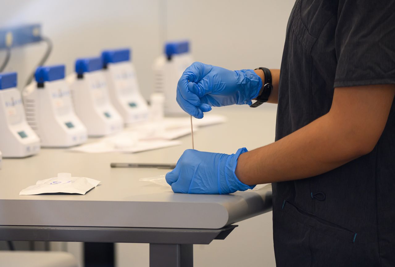 A medical worker performs a rapid COVID-19 test at a COVID-19 Rapid Test Center in Manhattan, New York, on December 8. 