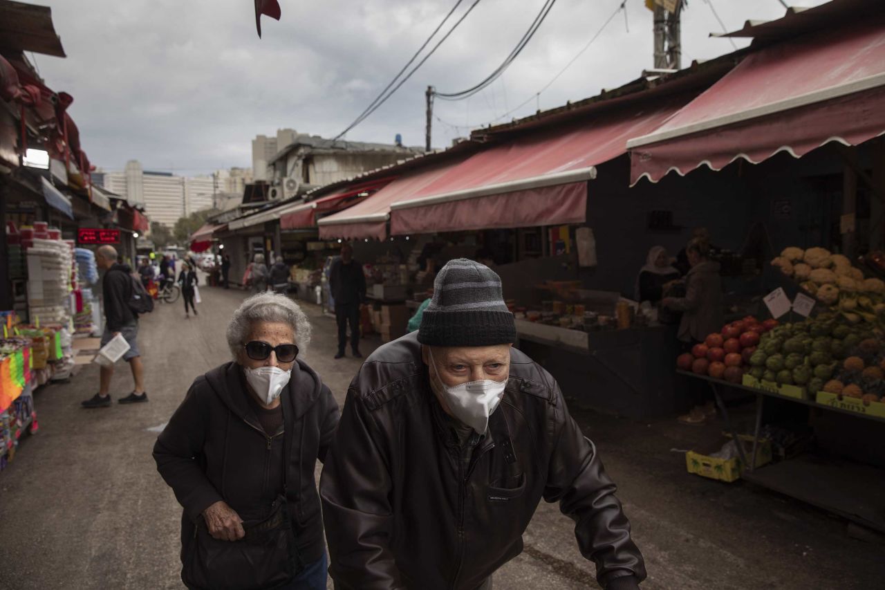 An elderly couple wear face masks as they shop at a food market in Tel Aviv, Israel, on Tuesday.