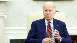 President Joe Biden speaks to reporter\ in the Oval Office  on Friday, May 12.