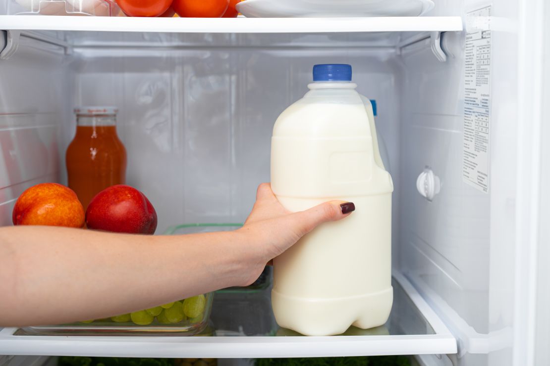 female-hand-reaching-for-milk-jug-in-fridge.jpg