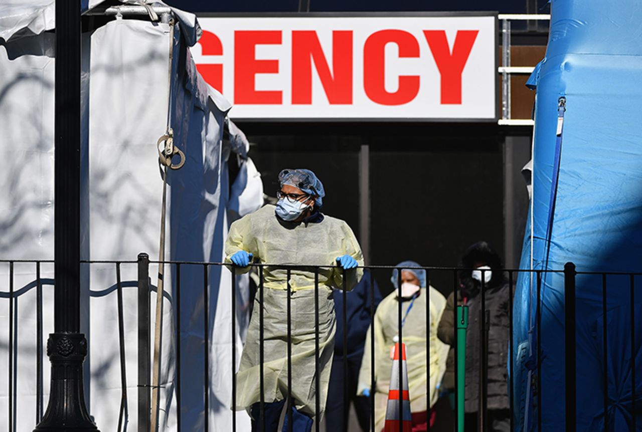 Medical workers outside at Elmhurst Hospital Center in New York City on March 26. Images from the situation at the hospital reportedly played a major role in Trump's decision to keep federal guidelines in place.