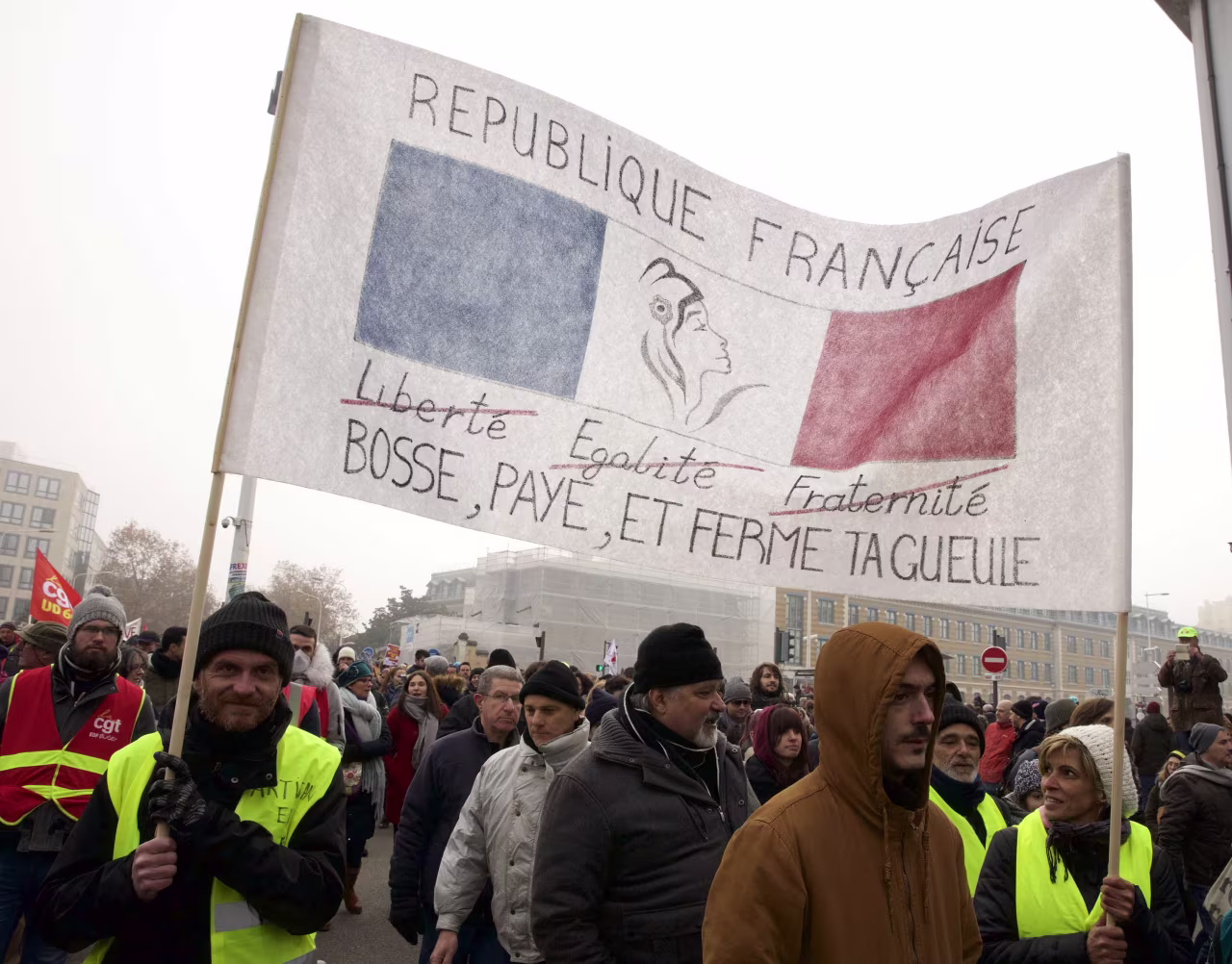 People march through Lyon in protest at proposed reforms to the French pension system. The slogan on the sign reads: "Work, pay, and shut your mouth." Photo: James Colburn/ZUMA Wire