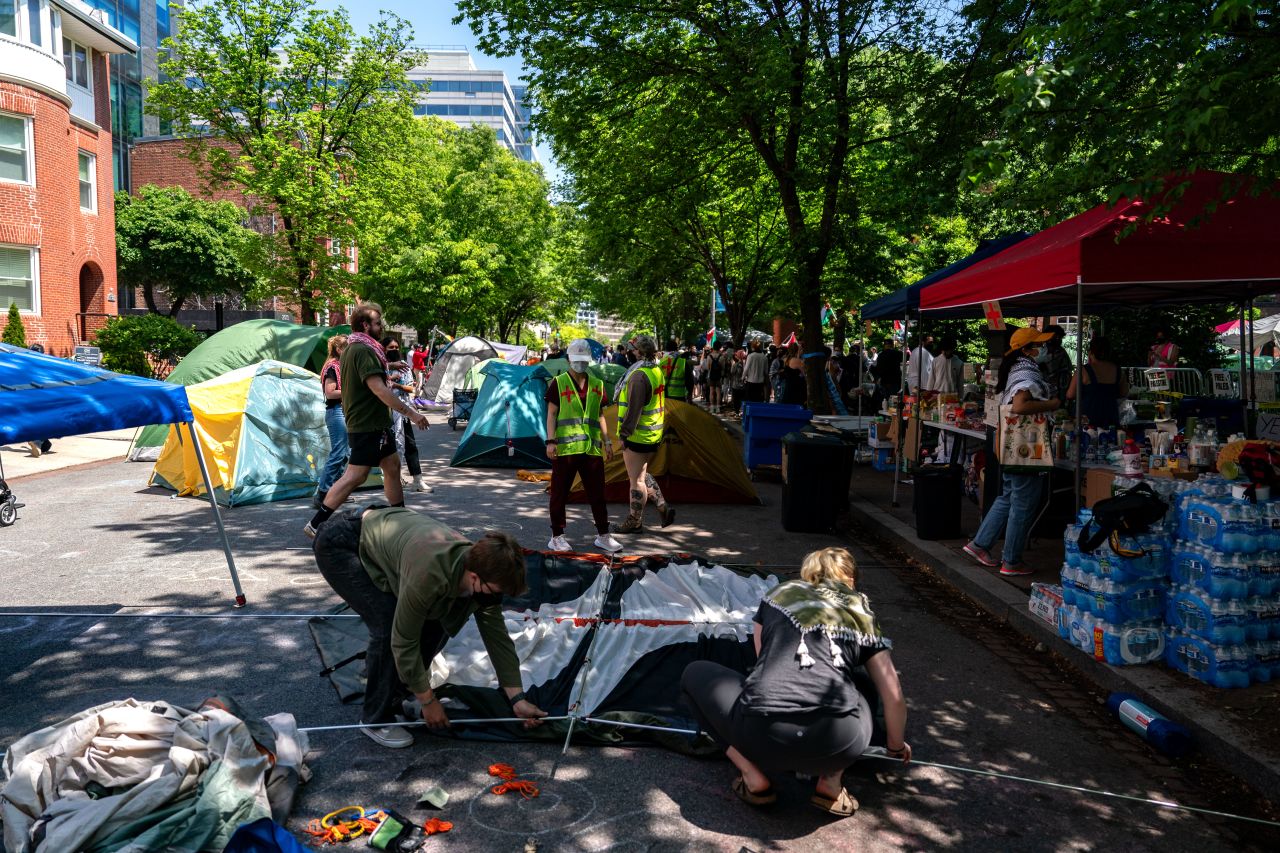 People set up more tents along H street as they protest at George Washington University in Washington, DC, on April 28. 