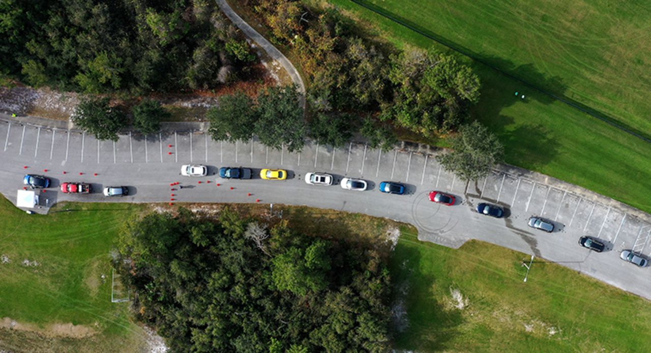 People line up in their cars to receive their first dose of the Moderna COVID-19 vaccine at a drive-thru vaccination event for residents 65 and older at Dewey O. Boster Park and Sports Complex on January 7,  in Deltona, Florida. 