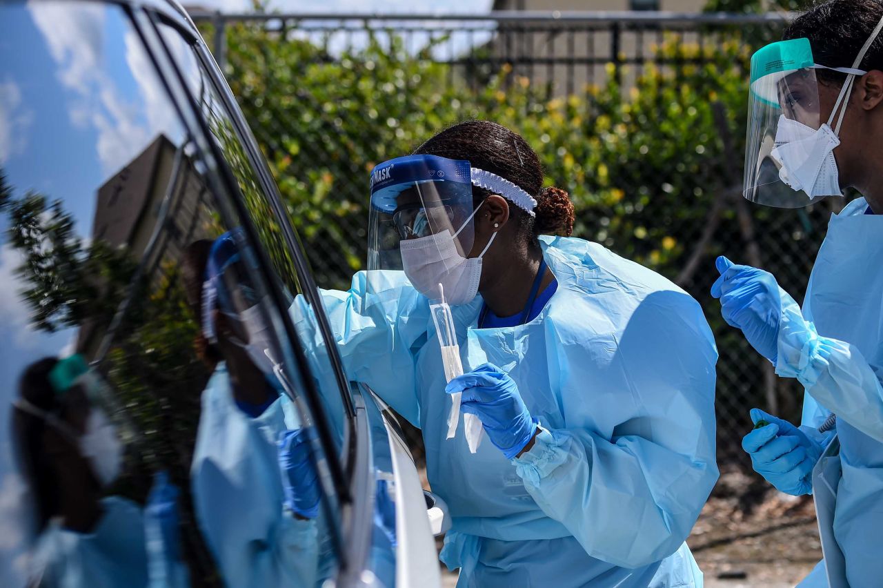 Medical personnel take samples at a "drive-thru" coronavirus testing lab in West Palm Beach, Florida, on March 16.